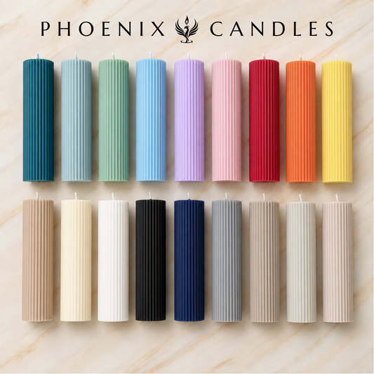 a collection of twelve cylindrical candles in various colors, arranged in a grid-like pattern on a marble surface.