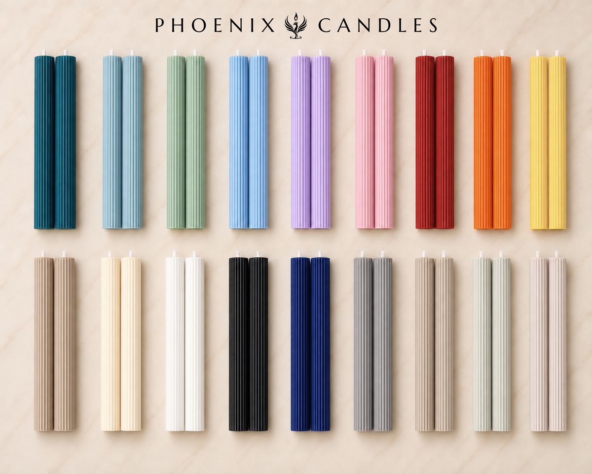 a collection of 16 candles in various colors and shapes, arranged in a grid-like pattern on a light-colored background.