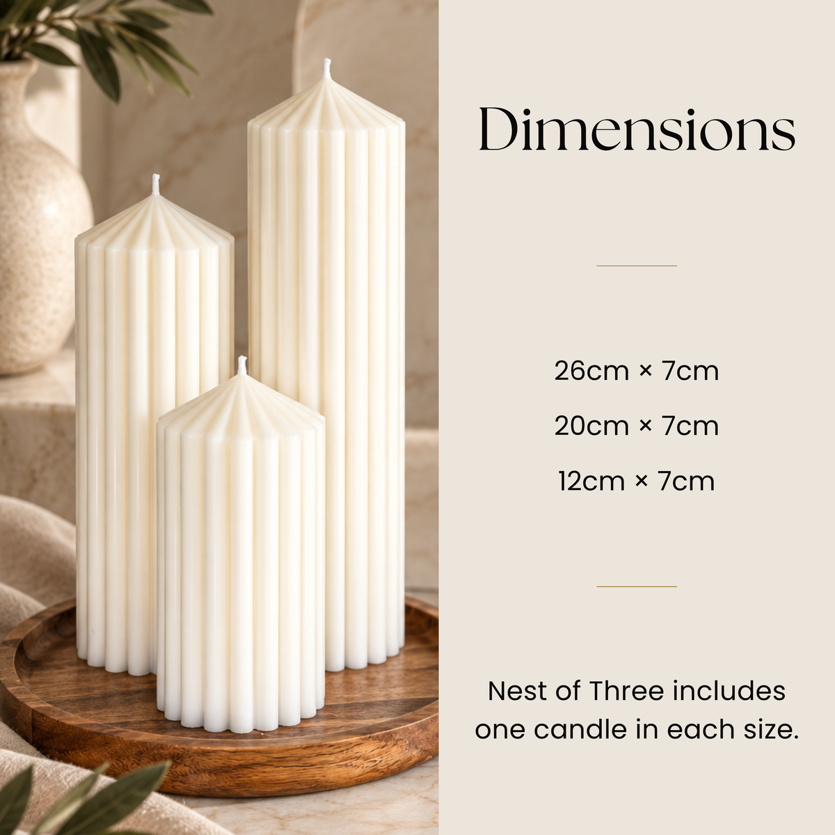 three white candles of different sizes, placed on a wooden tray. The candles are arranged in a row, with one larger candle in the center and two smaller ones on either side. The image also includes text providing dimensions and a description of the "Nest of Three".